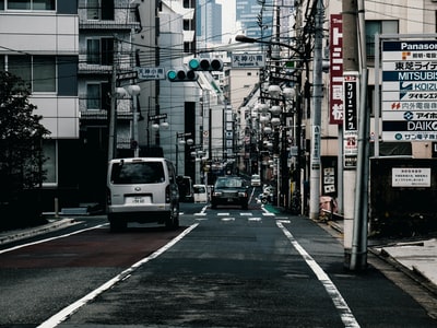 Highway surrounded by building the grey vehicles during the day
